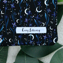 Load image into Gallery viewer, Pictured is a detailed close-up of Selene's Garden, with the Cozy Library tag sewn in.