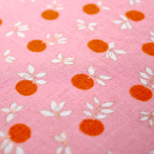 Load image into Gallery viewer, An angled close up picture of Peachy Keen's fabric, showing off the Pink/ Rose-Gold details in the overall design.