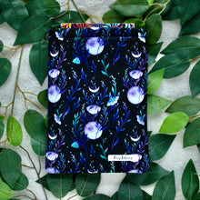Load image into Gallery viewer, A book is peeking out of Lunar Magic. Flat Lay style, taken from birds eye view.