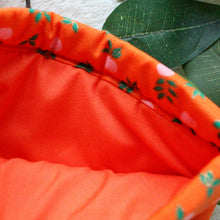 Load image into Gallery viewer, NRWO being held open. Inside you see the matching orange inlay fabric.