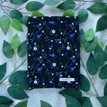 Load image into Gallery viewer, Night Blooms is pictured in a Flat Lay style, with multi-coloured green leaves as a background.