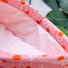 Load image into Gallery viewer, Peachy Keen is held open, and inside you can see a lighter pink inlay fabric that matches the outer fabric in away that is subtle and complimentary.