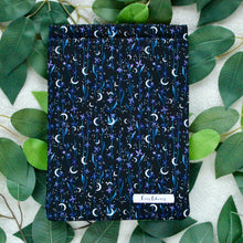 Load image into Gallery viewer, Selene's Garden as a Flat Lay, pictured against multi-coloured green leaves (as a background).