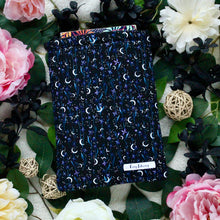 Load image into Gallery viewer, Selene's Garden is pictured with various black, pink and yellow-white flowers, in a flat lay style, taken from birds eye view.