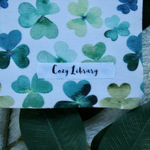 Load image into Gallery viewer, A detailed close up of Shamrock Fields, also shown is our sewn-in Cozy Library tag.