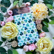 Load image into Gallery viewer, A Flat Lay of ShamrockFields with yellow, and pink, flowers around the sleeve for an artsy touch.