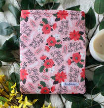 Load image into Gallery viewer, Red flowers, white flowers, Holly and white foliage adorn the fabric. There are the words "Festive as Fuck" in cursive font make up the outer fabric design in this "Festive AF" book sleeve. Size Medium.