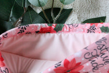 Load image into Gallery viewer, Festive AF is being held open. Inside there is a soft pink fabric inlay.