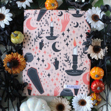 Load image into Gallery viewer, Cozy Occult is pictured with different coloured flowers, and small pumpkins serving as a background.