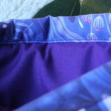 Load image into Gallery viewer, Purple Forest Guardian is being held open. In the sleeve there's a matching purple fabric inlay.