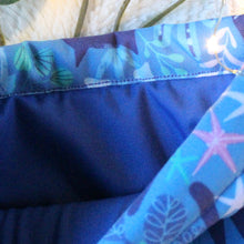 Load image into Gallery viewer, A Blue Forest Guardian is being held open. A blue fabric lines the inside of the Blue Forest Guardian book sleeve.