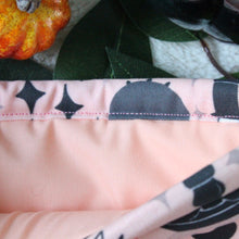 Load image into Gallery viewer, Cozy Occuly is being held open, which shows a light peach fabric inlay.