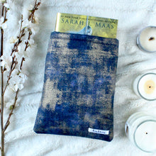 Load image into Gallery viewer, Indigo Gold Dust is captured with a hardcover copy of Kingdom of Ash. Picture is titled to the right.