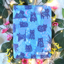 Load image into Gallery viewer, Forest Guardian as a Small sized book sleeve is shown. Throughout the photo there are pink and yellow flowers. There are leaves beneath everything. Fairylights are used in the picture to give the photo a fantasy-esque feel.