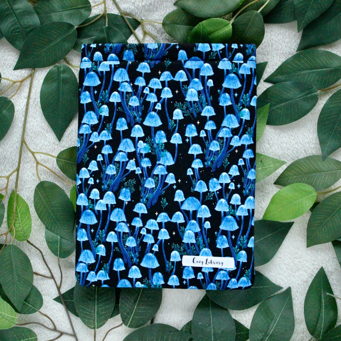 Moonlight Magic is placed atop some leaves, picture is taken in a flat lay style.