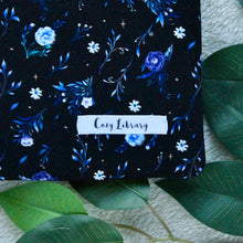 Load image into Gallery viewer, A detailed close-up of Night Blooms is pictured, with the Cozy Library tag also seen sewn into the sleeve.
