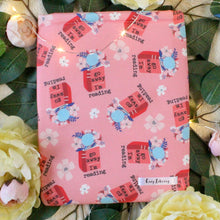 Load image into Gallery viewer, A book pink book sleeve with open an open book that has flowers coming out of it. The book reads &quot;Go away, I&#39;m reading&quot; in black text. The background of the fabric is a light pink.
