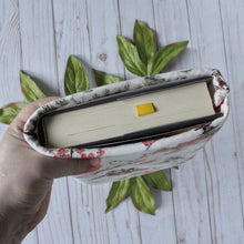 Load image into Gallery viewer, A closer look at how a book will fit into a book sleeve. Shown is a Medium sized Bashful Butterly book sleeve.
