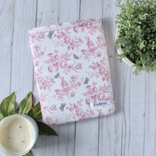 Load image into Gallery viewer, Shown is a Medium book sleeve. The fabric design is pink flowers and leaves with grey butterflies. The fabric design is a repeat pattern.
